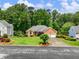 Charming brick home featuring a two-car garage and a beautifully landscaped front yard at 2910 Waverly Place Dr, Dacula, GA 30019