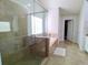 Bathroom showcasing glass shower door, separate tub, and a view to the walk-in closet at 3943 Ridge Grove Way, Suwanee, GA 30024