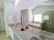 Spacious bathroom with double sink vanity and a large mirror reflecting the layout of the room at 3943 Ridge Grove Way, Suwanee, GA 30024
