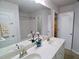 Bathroom showcasing a double sink vanity, white cabinets, neutral countertops, and a shower/tub combo at 3943 Ridge Grove Way, Suwanee, GA 30024