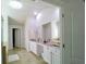 Bright bathroom featuring a double sink vanity and a view into the separate lavatory at 3943 Ridge Grove Way, Suwanee, GA 30024