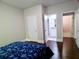 Bedroom with hardwood floors and a door leading to an ensuite bathroom for added privacy at 3943 Ridge Grove Way, Suwanee, GA 30024