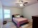 Comfortable bedroom with a ceiling fan, natural light and calm pastel color for a serene setting at 3943 Ridge Grove Way, Suwanee, GA 30024