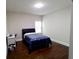 Comfortable bedroom featuring hardwood floors and a cozy blue floral comforter for a relaxing retreat at 3943 Ridge Grove Way, Suwanee, GA 30024