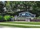 The Highlands at Duluth community sign surrounded by lush greenery and landscaping at 3943 Ridge Grove Way, Suwanee, GA 30024