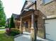 Inviting front porch with stone accents and lush landscaping enhancing curb appeal at 3943 Ridge Grove Way, Suwanee, GA 30024