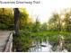 Scenic view of the Suwanee Greenway Trail with a wooden path and lush greenery at 3943 Ridge Grove Way, Suwanee, GA 30024