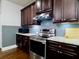 Close up of the kitchen featuring stainless steel appliances and dark wood cabinets at 3943 Ridge Grove Way, Suwanee, GA 30024