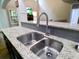 The kitchen features a stainless steel sink and a large granite countertop at 3943 Ridge Grove Way, Suwanee, GA 30024