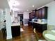 Spacious kitchen with dark cabinets, stainless steel appliances, and a breakfast nook at 3943 Ridge Grove Way, Suwanee, GA 30024