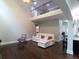 Open-concept living area with hardwood floors, vaulted ceiling, and comfortable seating at 3943 Ridge Grove Way, Suwanee, GA 30024