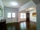 Open-concept living room featuring hardwood flooring and double doors to the outside at 3943 Ridge Grove Way, Suwanee, GA 30024