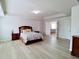 Large main bedroom with a tray ceiling, neutral walls, wood-look floors, and two large windows at 3943 Ridge Grove Way, Suwanee, GA 30024