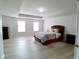 Spacious main bedroom with a tray ceiling, light walls, wood-look floors, and two large windows at 3943 Ridge Grove Way, Suwanee, GA 30024