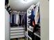 Organized walk-in closet with shelves, hanging rods, and drawers for optimal storage at 3943 Ridge Grove Way, Suwanee, GA 30024