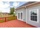 An exterior view shows the deck with glass doors to enter the home at 535 Sugar Gate Ct, Lawrenceville, GA 30044