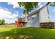 Well-maintained backyard featuring a spacious lawn, wooden fence, and a deck with stairs, great for entertaining at 535 Sugar Gate Ct, Lawrenceville, GA 30044