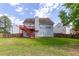 Spacious backyard with lawn, wood fence, and deck, offering a private outdoor space for recreation and gatherings at 535 Sugar Gate Ct, Lawrenceville, GA 30044