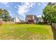 Expansive backyard with green grass, fenced perimeter, and deck, ideal for outdoor enjoyment and Gathering activities at 535 Sugar Gate Ct, Lawrenceville, GA 30044