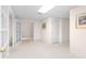 Neutral basement features plush carpeting, white trim, and an art print to add color to the room at 535 Sugar Gate Ct, Lawrenceville, GA 30044