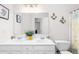 Bright bathroom with a double sink vanity, decorative sconces and a full sized mirror at 535 Sugar Gate Ct, Lawrenceville, GA 30044