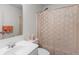 Bathroom featuring a shower, toilet, and sink with soft colors at 535 Sugar Gate Ct, Lawrenceville, GA 30044