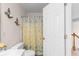 Bathroom featuring a vanity sink, toilet, decorative sconces, and a shower with blue floral curtains at 535 Sugar Gate Ct, Lawrenceville, GA 30044