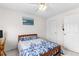 This cozy bedroom is staged with blue bedding and has window and a side table at 535 Sugar Gate Ct, Lawrenceville, GA 30044