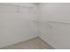 Walk-in closet with wire shelving and neutral carpeting, ready for organizing and storage solutions at 535 Sugar Gate Ct, Lawrenceville, GA 30044