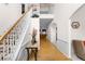 Spacious foyer featuring hardwood floors, white walls, a staircase, and an open view to the living area at 535 Sugar Gate Ct, Lawrenceville, GA 30044