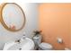 Cozy half bathroom featuring a modern sink, mirror, white fixtures, and a vibrant wall color at 535 Sugar Gate Ct, Lawrenceville, GA 30044
