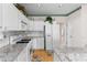 Well-lit kitchen with white cabinetry, granite countertops, and stainless steel appliances at 535 Sugar Gate Ct, Lawrenceville, GA 30044