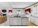 Bright kitchen features white cabinets, granite countertops and stainless steel dishwasher at 535 Sugar Gate Ct, Lawrenceville, GA 30044