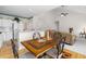 Sunlit kitchen and living room with open layout and wooden dining table at 535 Sugar Gate Ct, Lawrenceville, GA 30044