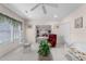 Well-lit living room boasts a ceiling fan and backyard views through the windows at 535 Sugar Gate Ct, Lawrenceville, GA 30044