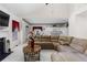 Living room featuring a stone fireplace, large windows, and a plush, neutral-toned sectional at 535 Sugar Gate Ct, Lawrenceville, GA 30044