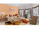 Bright living room with large windows, a cozy sofa, a patterned rug, and tasteful decor at 535 Sugar Gate Ct, Lawrenceville, GA 30044