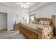 Spacious main bedroom with tray ceiling, plush bed, and access to a bathroom at 535 Sugar Gate Ct, Lawrenceville, GA 30044
