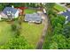 Aerial view of a landscaped yard, cozy ranch house, and a long driveway at 2221 Shallowford Rd, Marietta, GA 30066