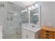 Bathroom featuring tiled shower, vanity with sink, and built-in shelving at 2221 Shallowford Rd, Marietta, GA 30066