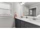 Bright bathroom featuring double sink vanity with gray cabinets and white countertop at 2221 Shallowford Rd, Marietta, GA 30066