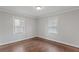 Clean and bright bedroom with hardwood floors and large windows offering lots of natural light at 2221 Shallowford Rd, Marietta, GA 30066