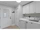 Functional laundry room with washer, dryer, and ample cabinet storage at 2221 Shallowford Rd, Marietta, GA 30066