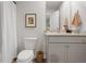 Bathroom featuring a shower with tub, toilet, vanity, and framed art at 225 Ivey Ter, Temple, GA 30179