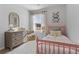 Bright bedroom with a window, dresser, bed, and butterfly art at 225 Ivey Ter, Temple, GA 30179
