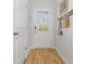 Bright entryway features wood-look floors, a white door with blinds, and decorative wall hooks at 225 Ivey Ter, Temple, GA 30179