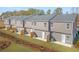 Back exterior view of new homes with a grass lawn and individual, fenced patios at 225 Ivey Ter, Temple, GA 30179