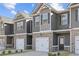 Charming townhome featuring a gray siding, brick accents, and a convenient one-car garage at 225 Ivey Ter, Temple, GA 30179