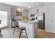 Modern kitchen with granite countertops, stainless steel appliances, and a cozy breakfast bar seating area at 225 Ivey Ter, Temple, GA 30179