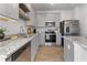 Stylish kitchen featuring gray cabinets, granite counters, stainless steel appliances, and a kitchen island at 225 Ivey Ter, Temple, GA 30179